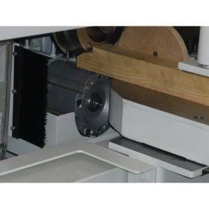 A wooden plank being processed in the Pentho Compact C3 Performance Tenoner
